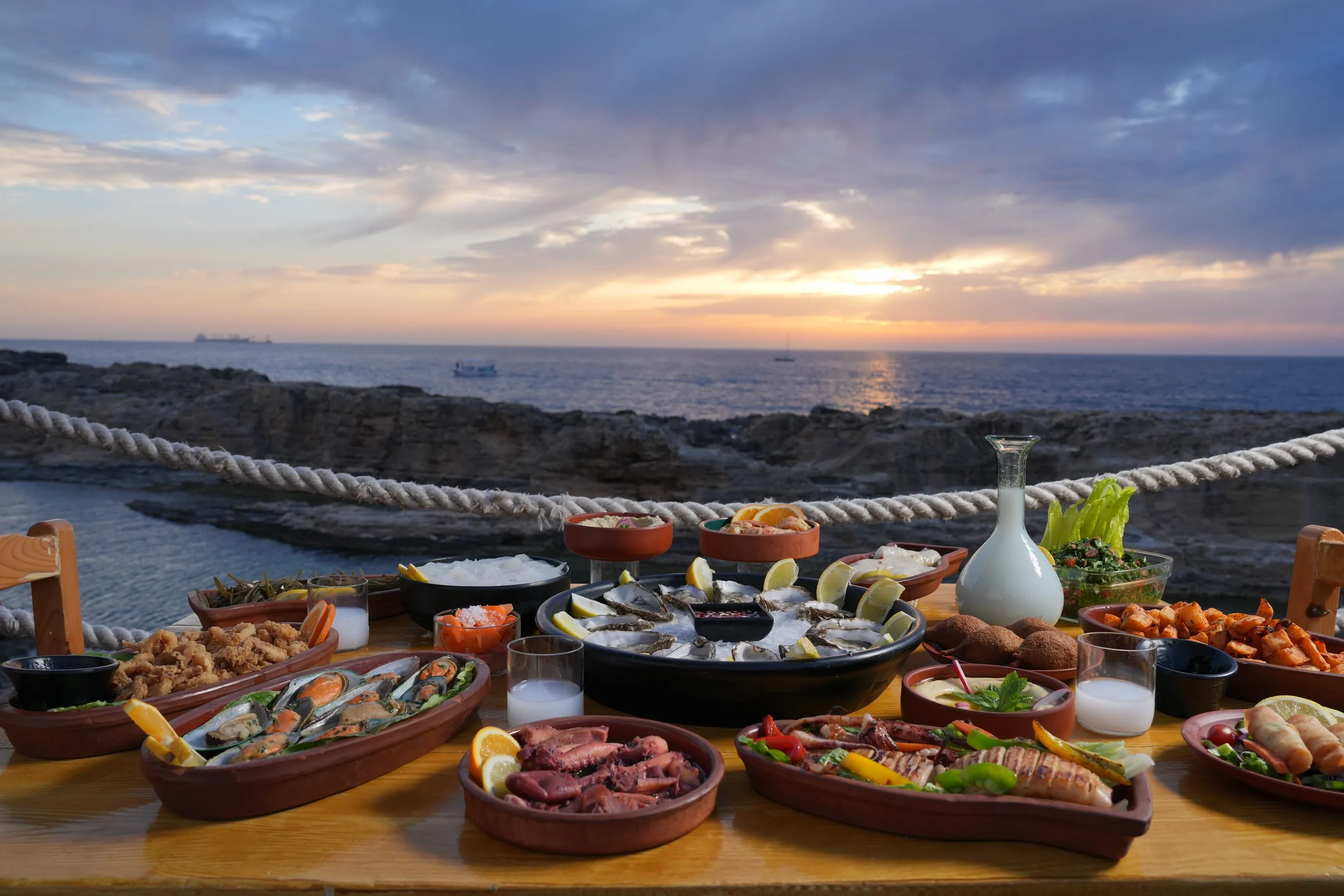 Seafood table at sunset on the terrace of Oyster's Seafood Bar, Batroun Mina