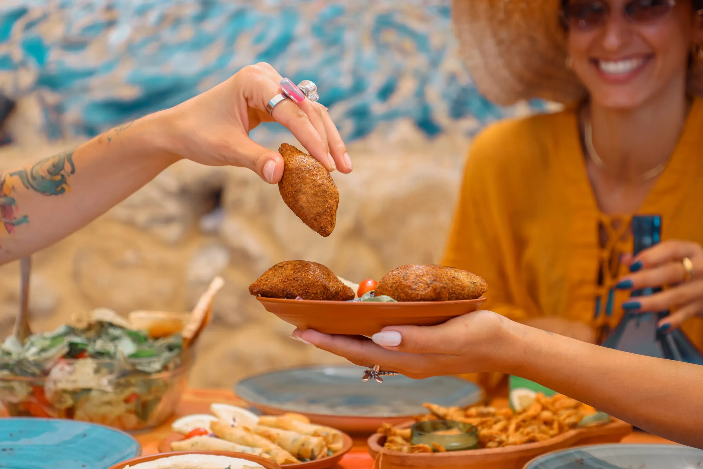 Fish kebbe passed across a shared table at Oyster's Seafood Bar, Batroun