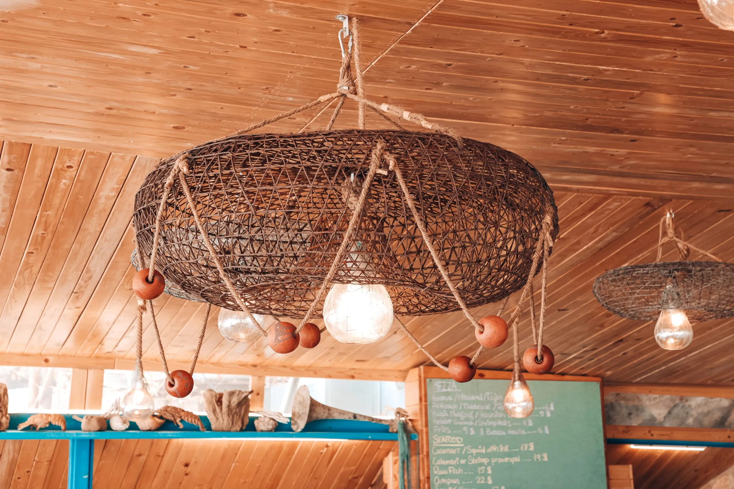 A fish trap turned into a pendant lamp under the wooden ceiling of Oyster's Seafood Bar, Batroun