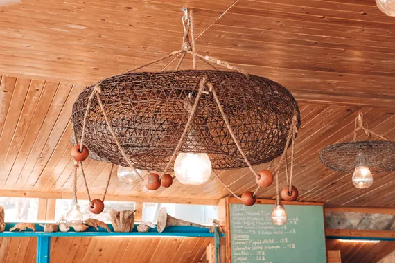 A fish trap turned into a pendant lamp under the wooden ceiling of Oyster's Seafood Bar, Batroun