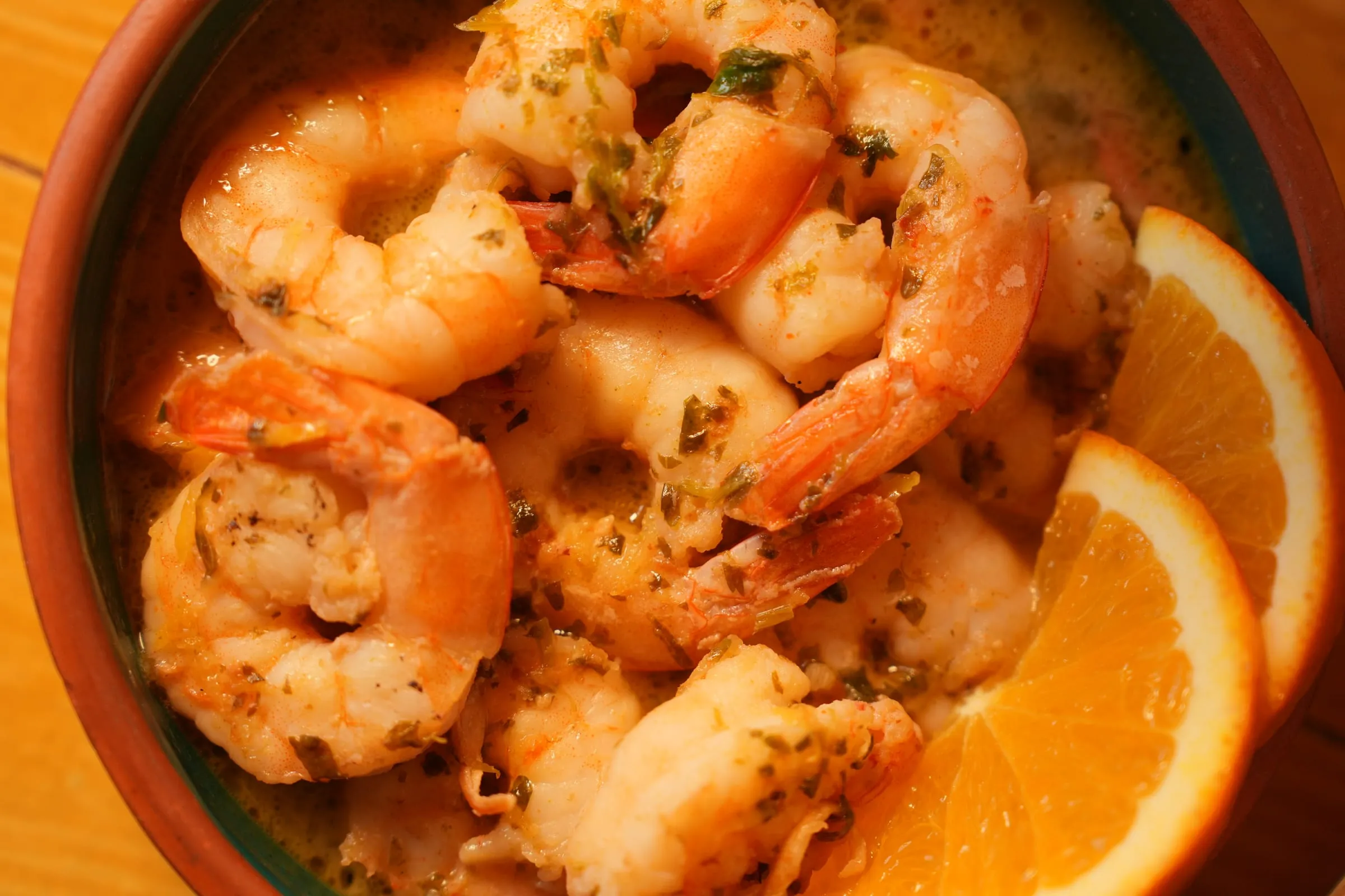 Shrimp in garlic and lemon sauce in a terracotta bowl at Oyster's Seafood Bar, Batroun